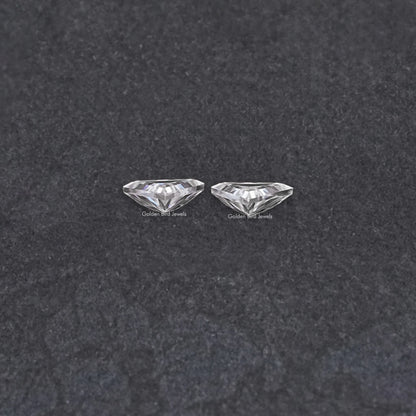 Pair of triangular moissanite stones, clear faceted close-up