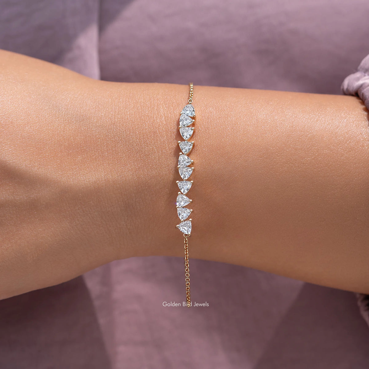 Gold lab-grown diamond line bracelet with marquise-cut stones on wrist