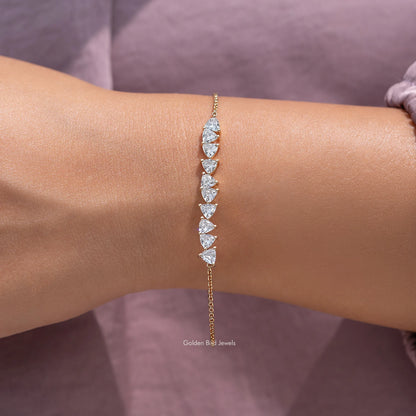 Gold lab-grown diamond line bracelet with marquise-cut stones on wrist
