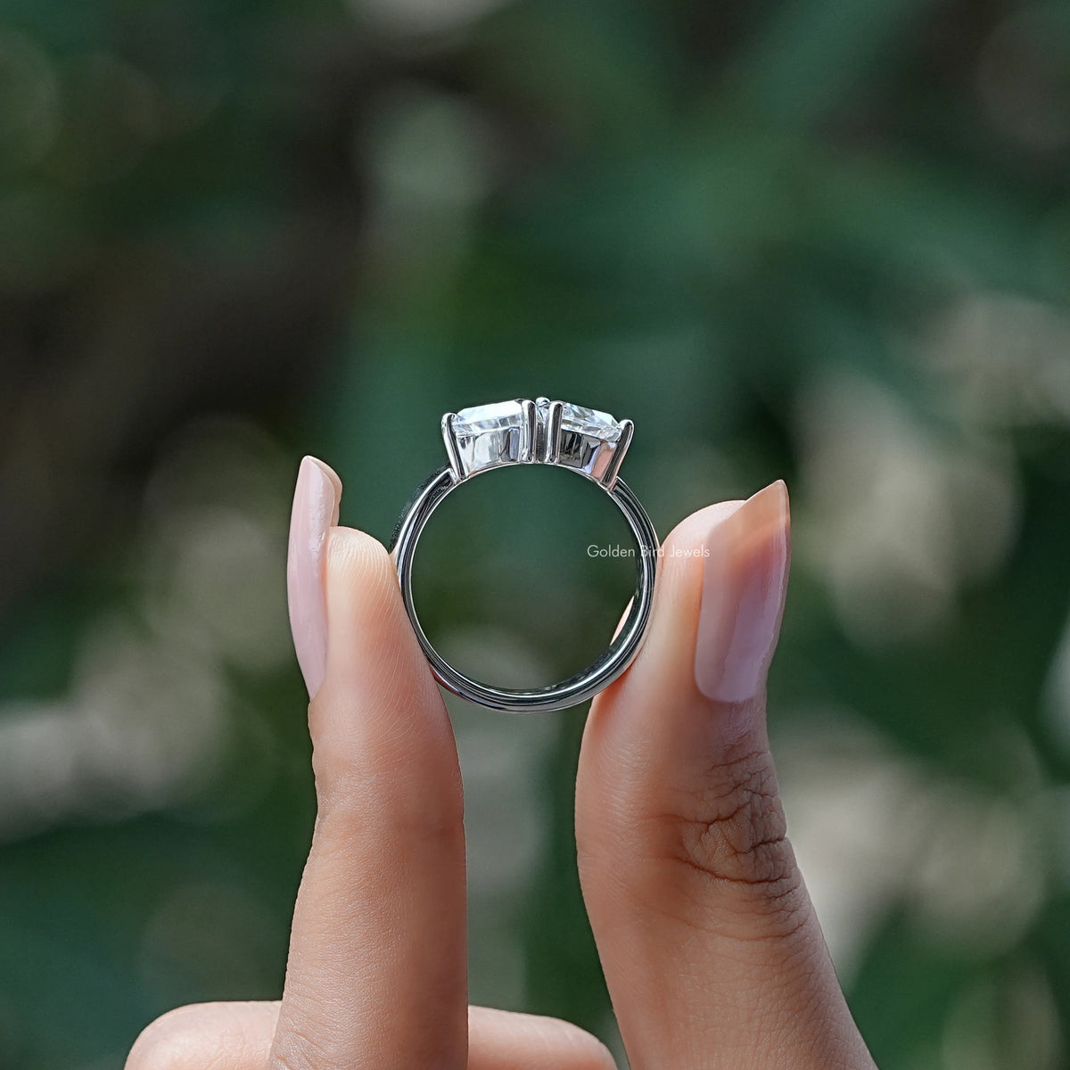 Back View of Trillion Two Stone Moissanite Engagement Ring In two fingers