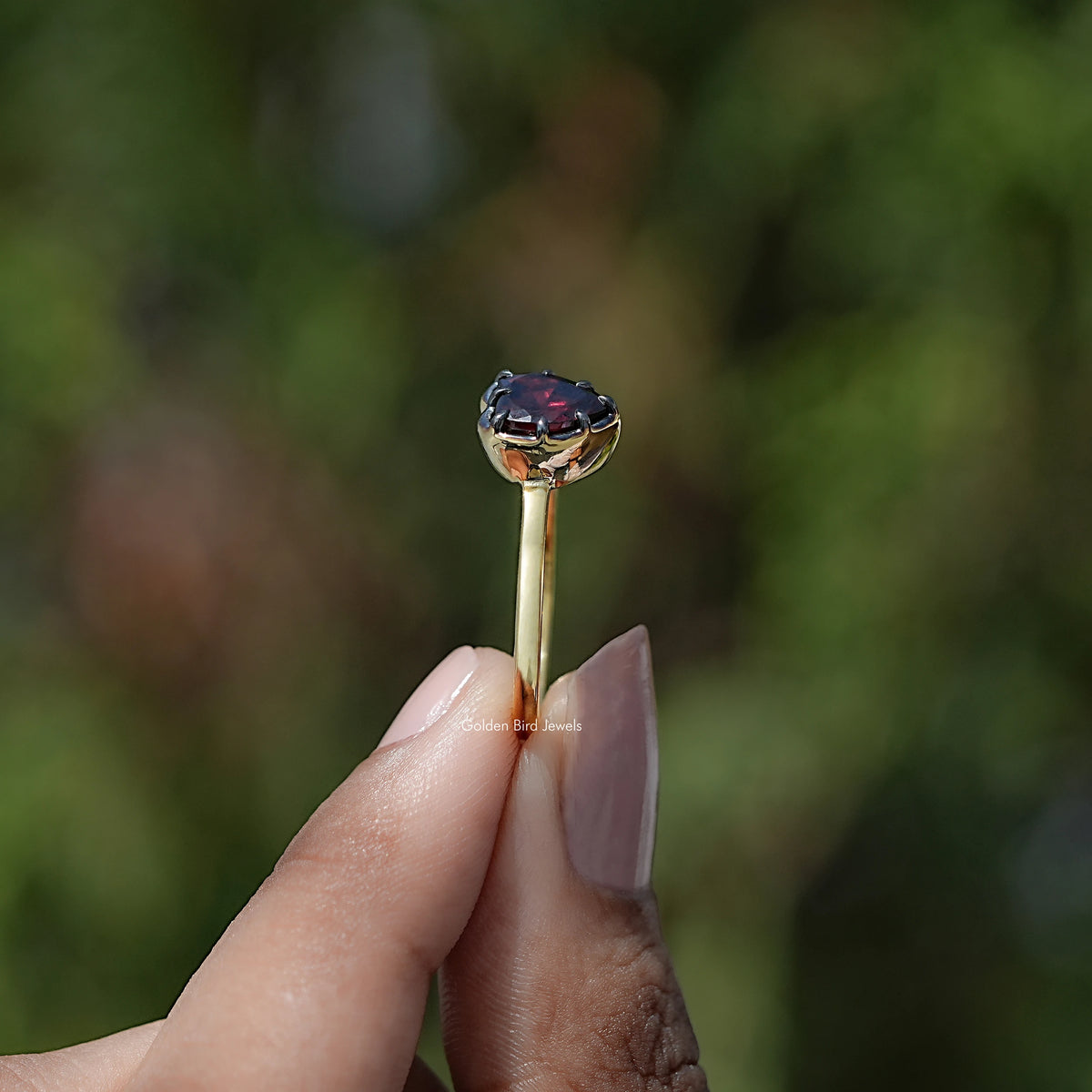 Heart two-stone ring side view with dark gemstone and silver-toned band