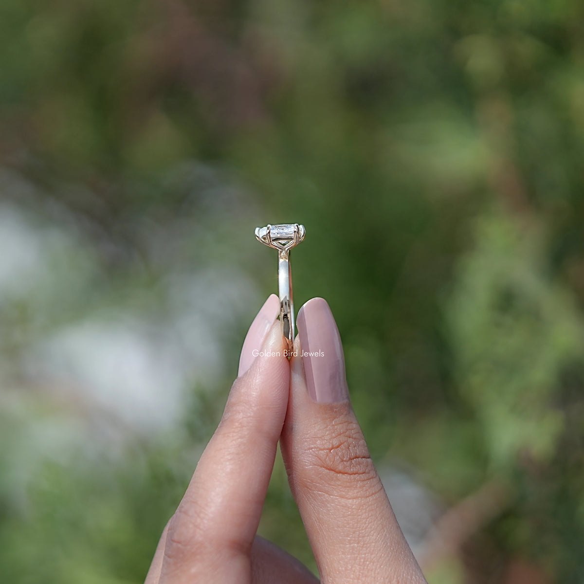 Moissanite pear-cut and princess-cut ring, top view with prong setting