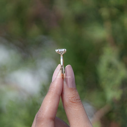 Moissanite pear-cut and princess-cut ring, top view with prong setting
