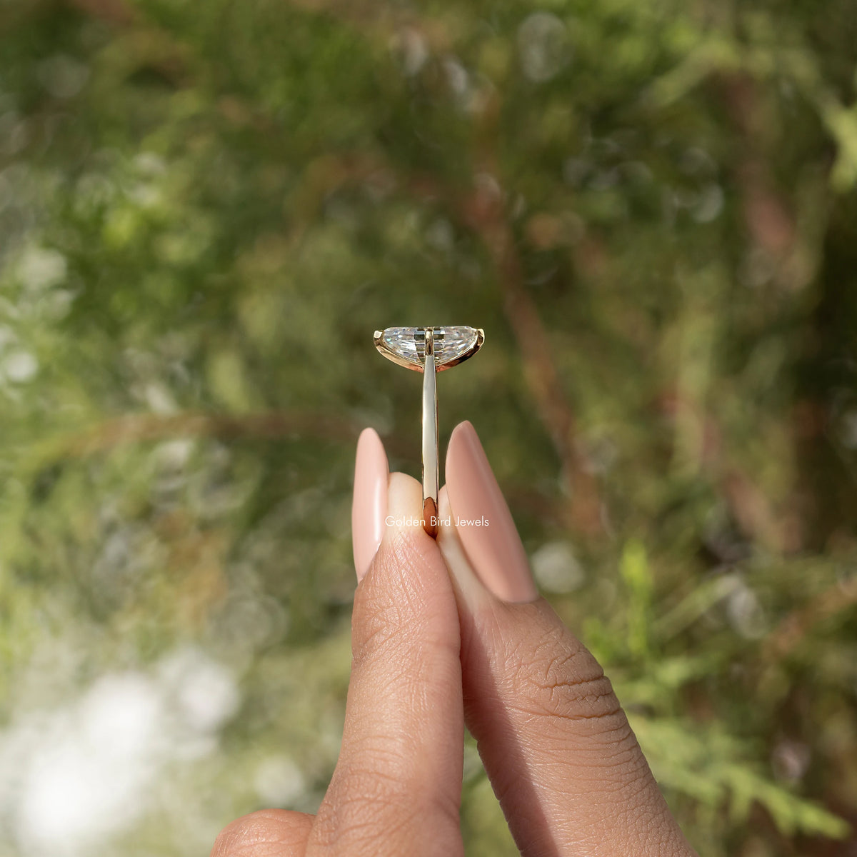 Gold-tone marquise step-cut moissanite ring with prong-set center stone