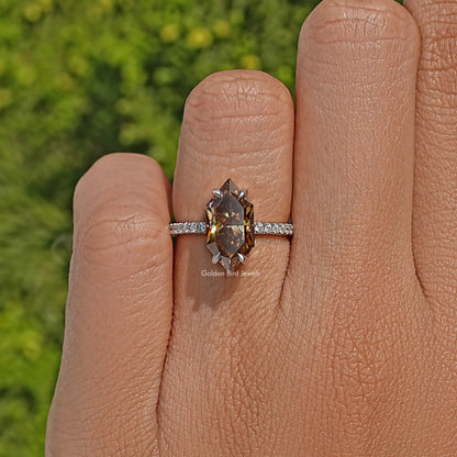 Marquise-cut moissanite ring with pavé band on a finger