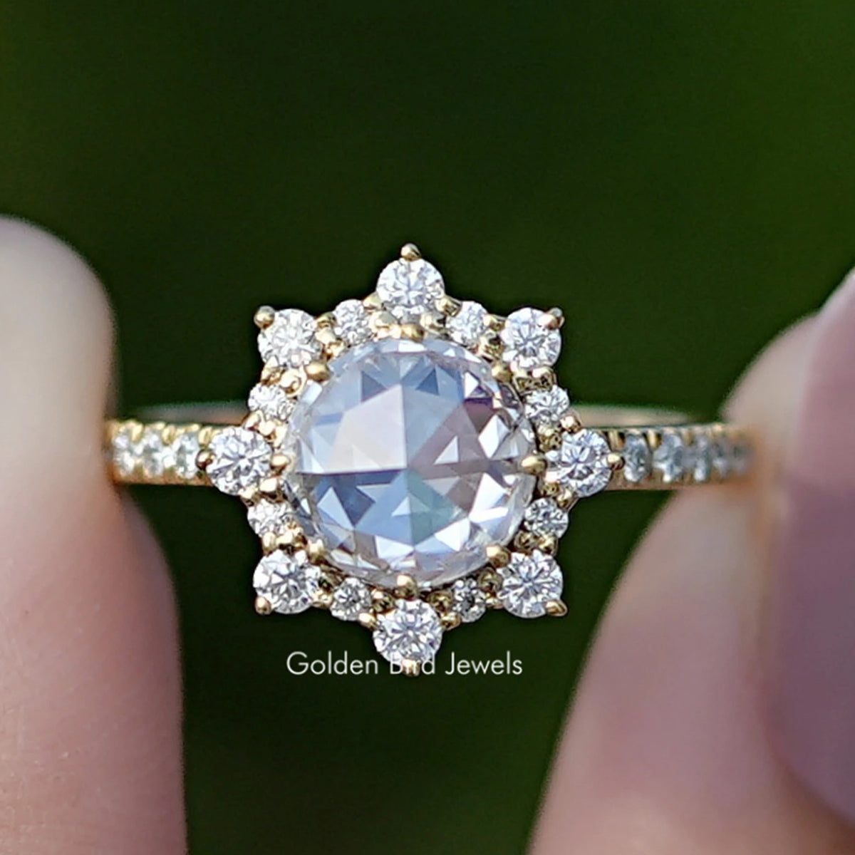 Gold-tone halo moissanite ring with round center stone and small side stones