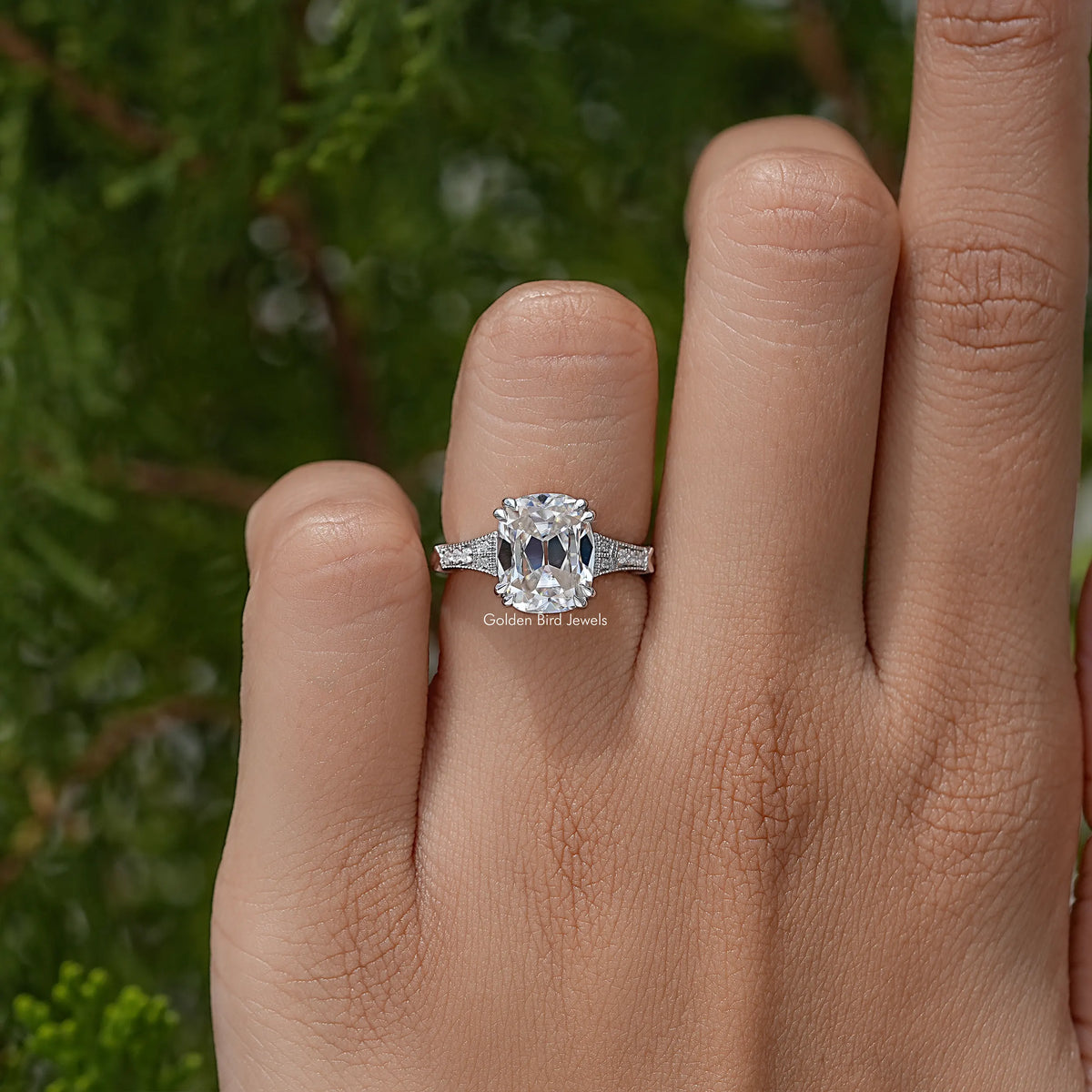 Vintage elongated cushion solitaire ring with clear center stone and pavé band