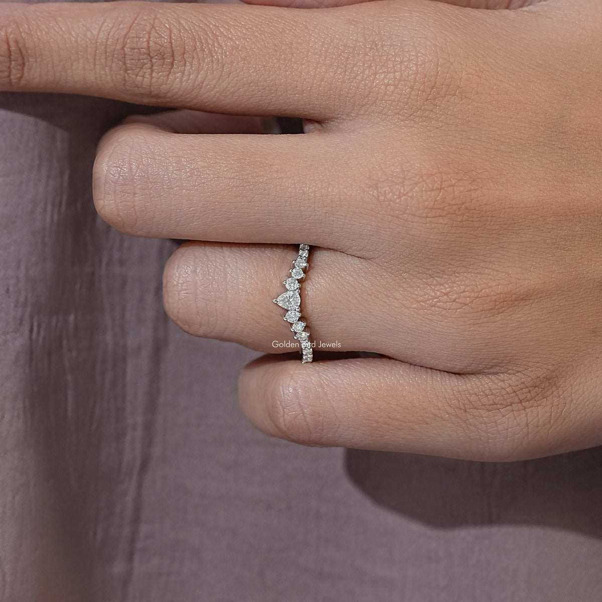 Silver chevron moissanite eternity band with pear-cut white stones, side profile