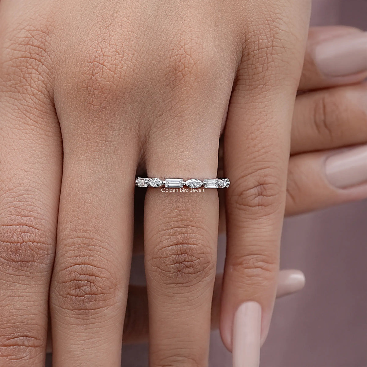 Silver full eternity ring with marquise and baguette-cut stones, worn on finger