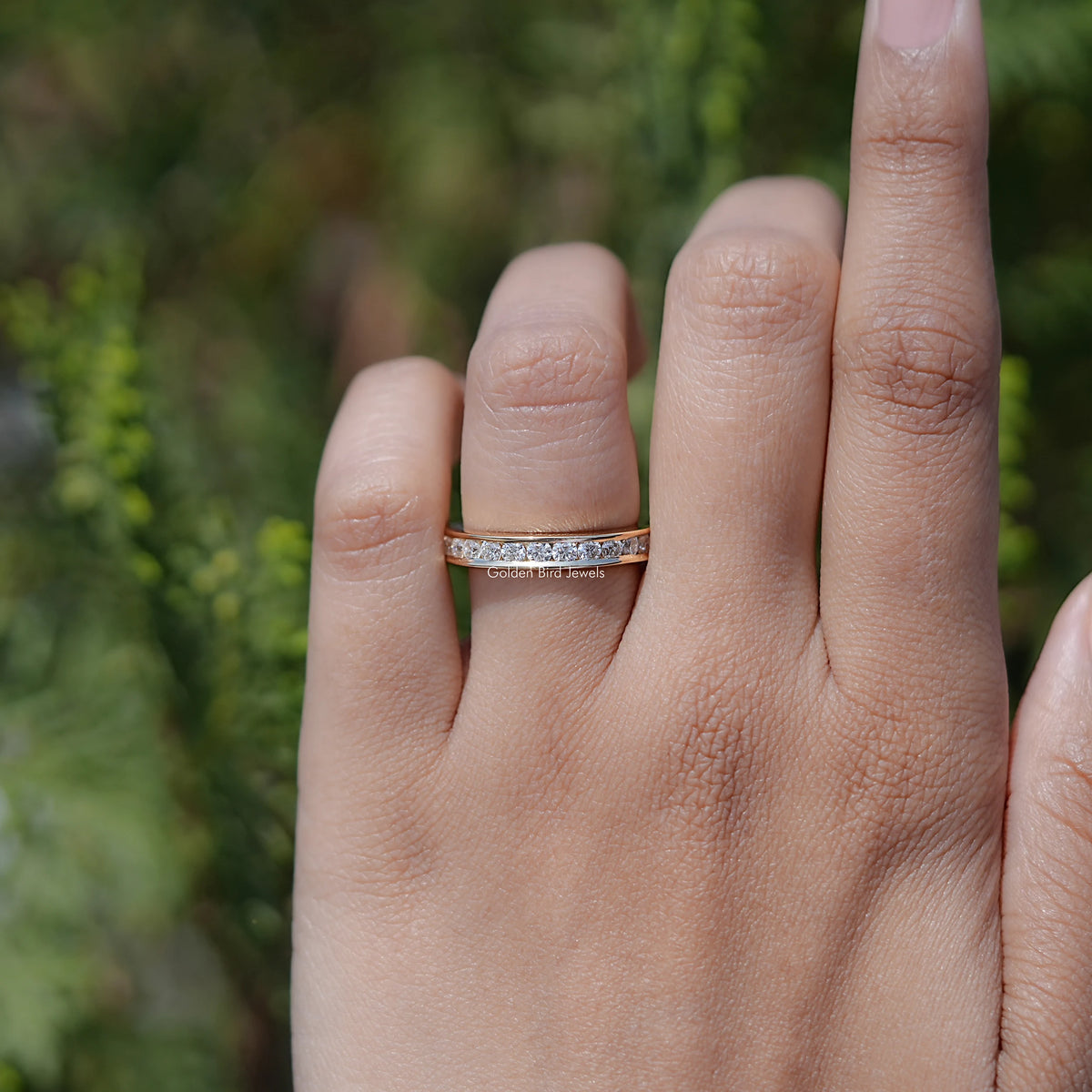 Silver half-eternity band on finger, slim profile with channel-set stones