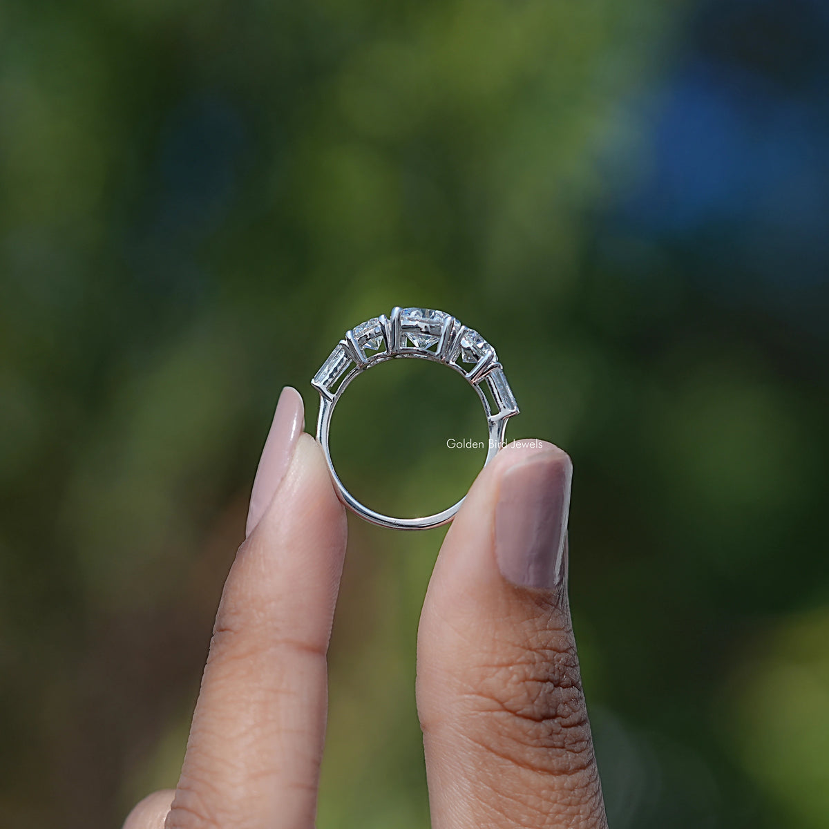 Five-stone 14K white gold ring with baguette diamonds on the band, side view