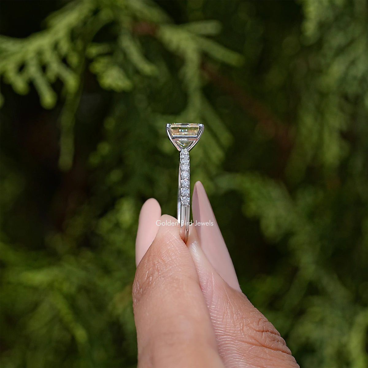Sterling silver ring top view on finger, with asscher-cut center gemstone setting
