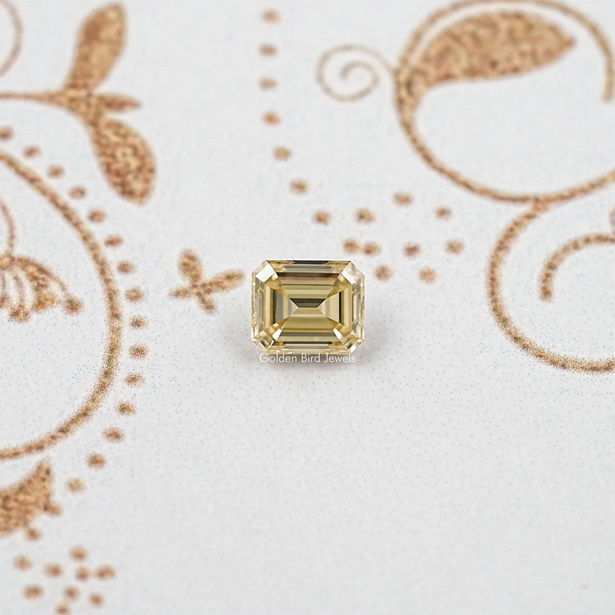 Yellow emerald-cut moissanite gemstone with square step facets, front view centerpiece.