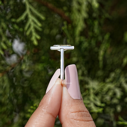 Silver marquise bezel ring showing raised top setting above the band