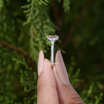 Sterling silver moissanite wedding ring with oval center stone and leaf side stones