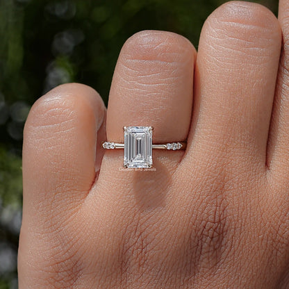 Emerald-cut lab diamond ring with prong-set center stone and slim side stones