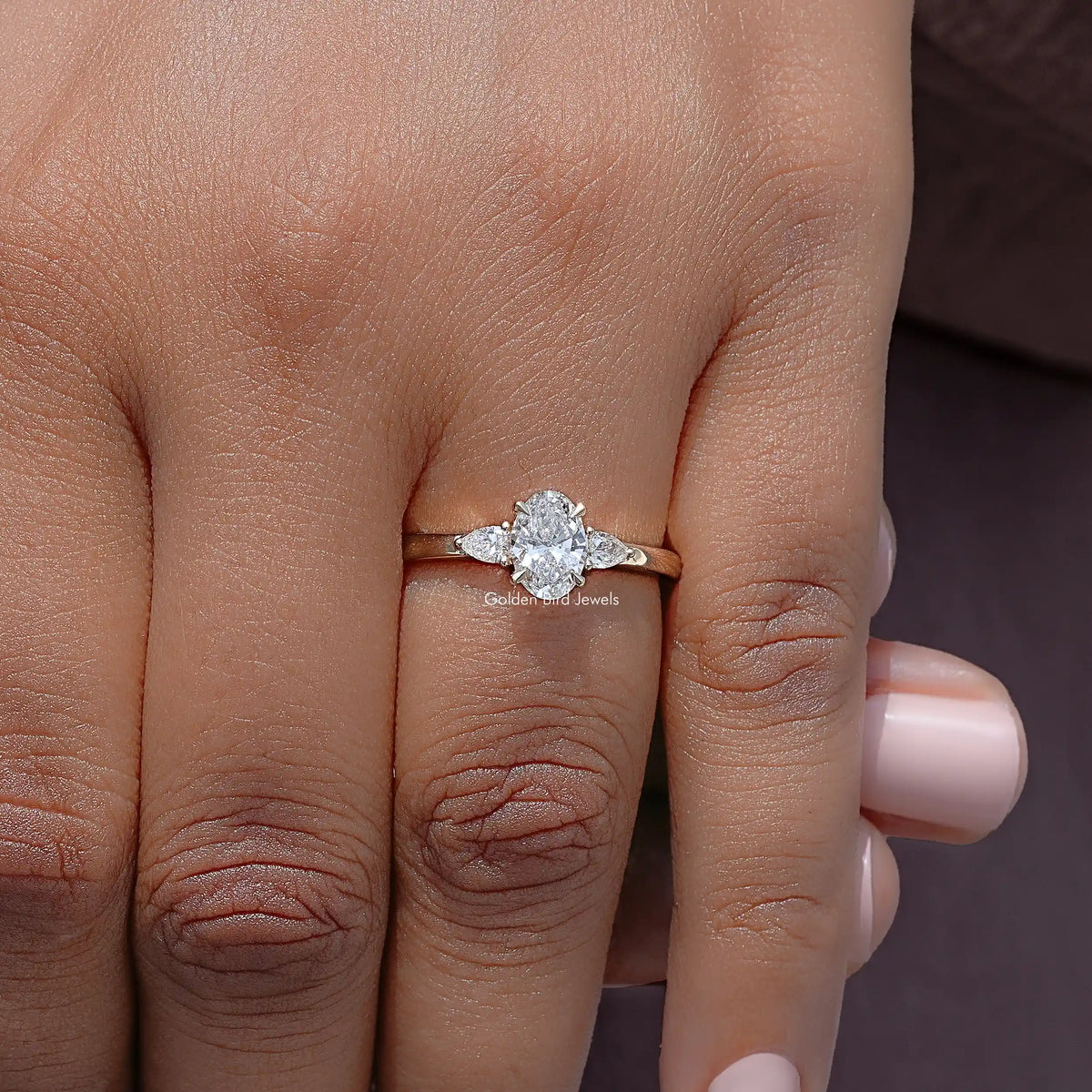 Three-stone lab-grown diamond anniversary ring, round center stone with two side stones