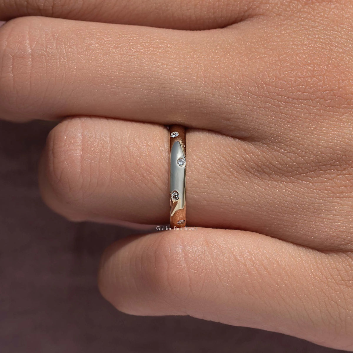 Flush-set diamond eternity band ring, close-up of band with round diamond settings