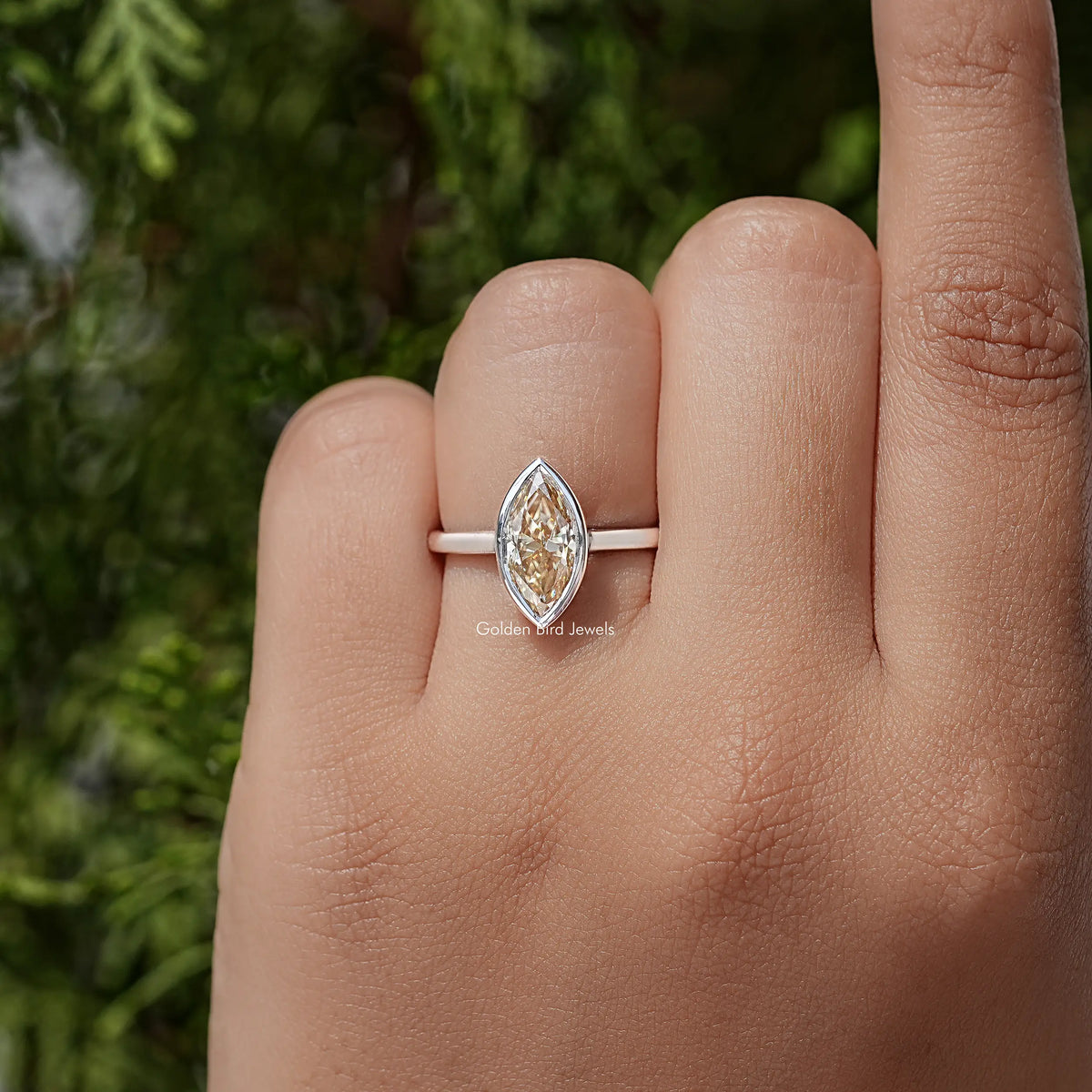 Marquise bezel ring with faceted marquise-cut center stone on slim silver band