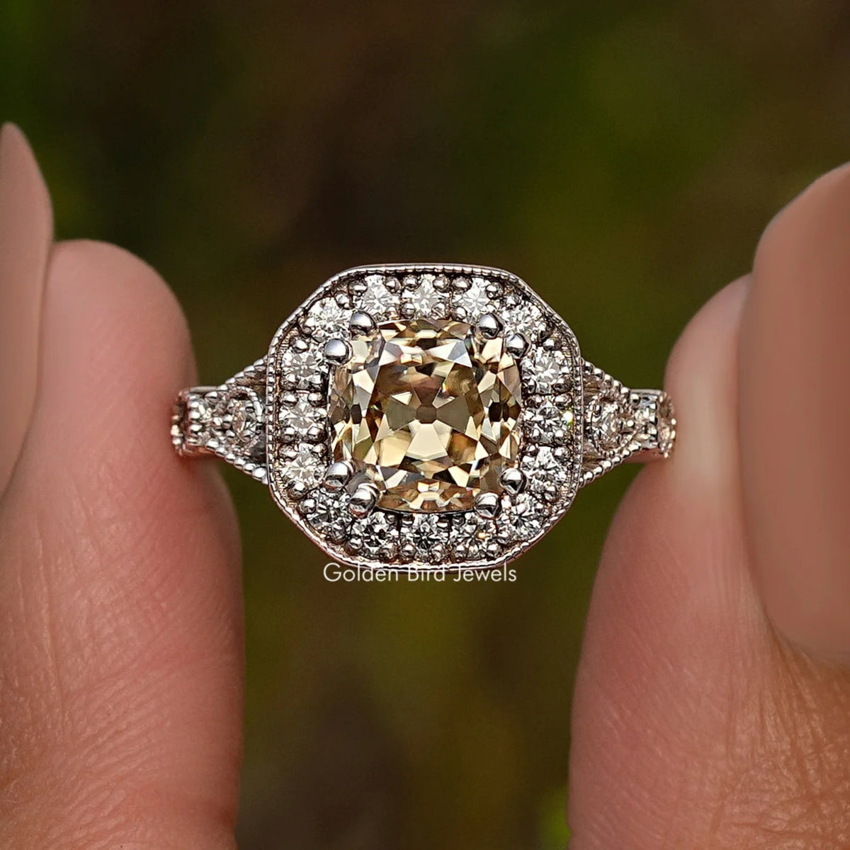 Sterling silver halo cushion ring with yellow center stone and sparkling side accents