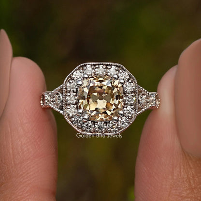 Sterling silver halo cushion ring with yellow center stone and sparkling side accents