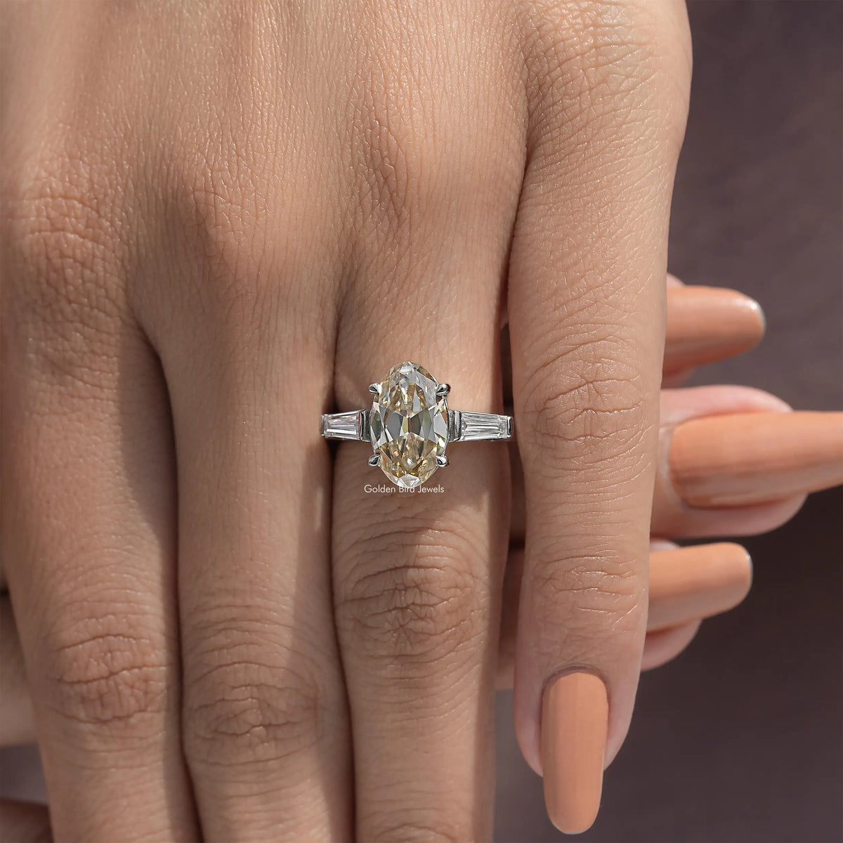 Oval yellow moissanite three-stone ring in sterling silver with baguette side stones