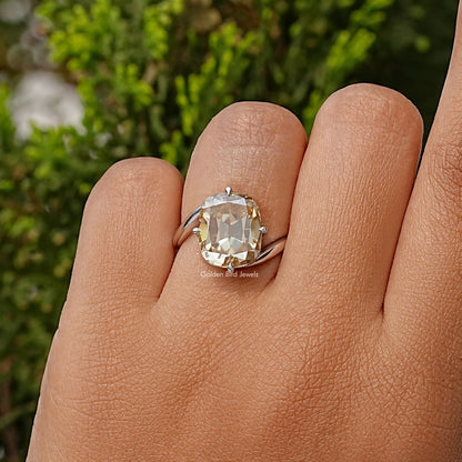 Clear cushion-cut moissanite solitaire ring in sterling silver, worn on hand