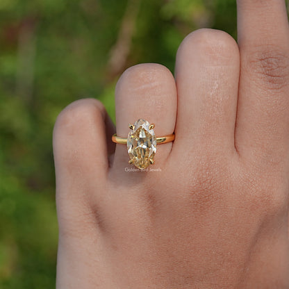 Gold-tone oval moissanite solitaire ring, thin band with oval center stone