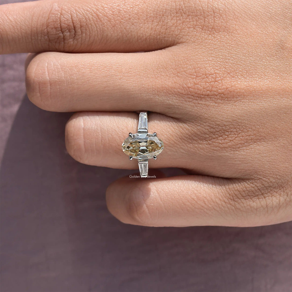 Sterling silver ring with oval yellow moissanite center and baguette side settings