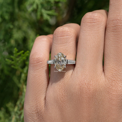 Sterling silver three-stone ring with oval yellow moissanite and baguette side stones