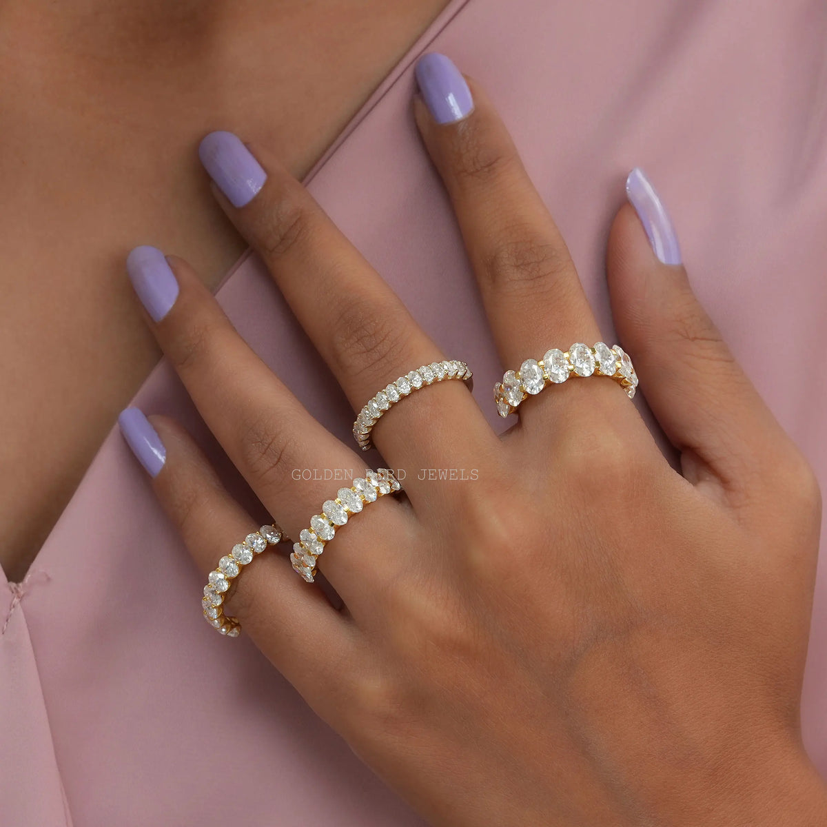 Oval-cut moissanite half-eternity wedding band on hand, oval-stone design