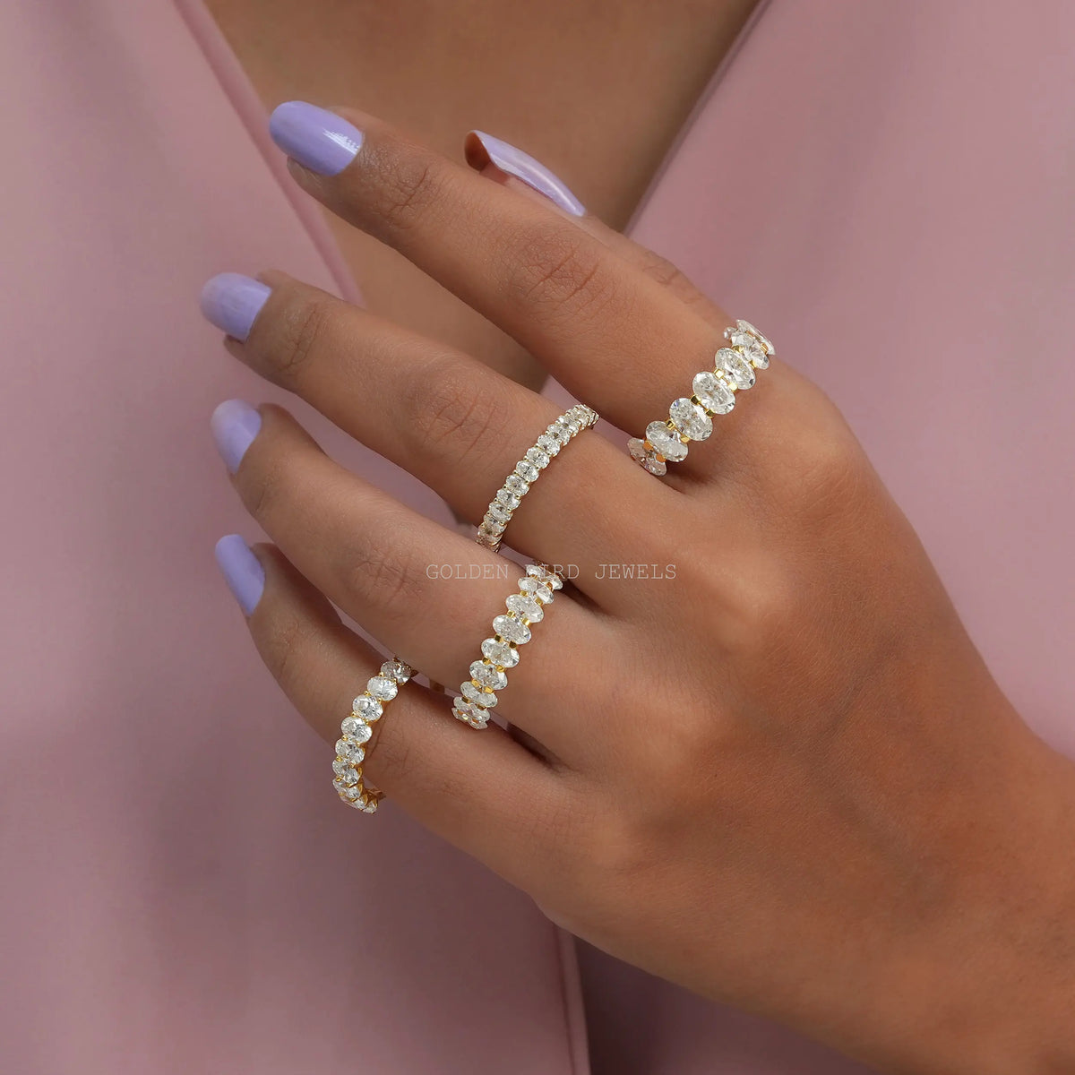 Oval-cut moissanite half-eternity wedding band on hand, row of oval stones
